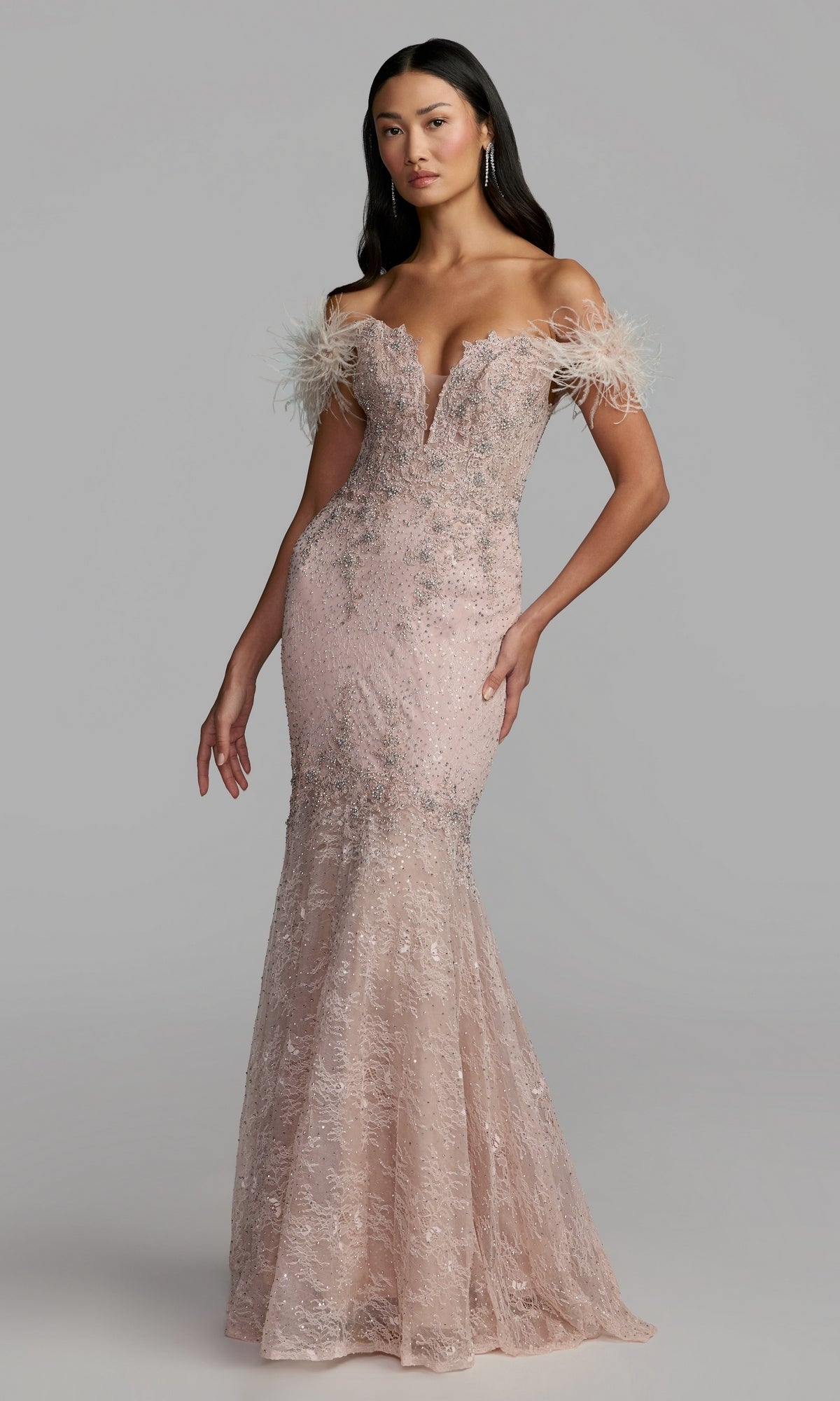 A woman poses in a lilac, off-the-shoulder long formal dress by Mac Duggal (style 20246), featuring feathered sleeve details and intricate beadwork for a truly elegant, beaded evening gown look.